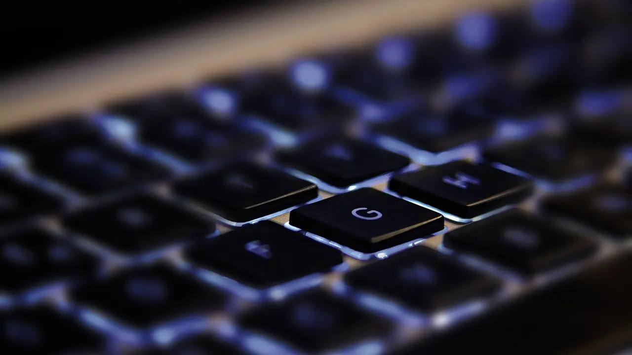 A writer typing an email on a laptop